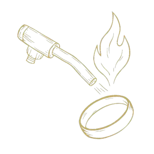 A blow torch heating a ring, likely for jewelry work or soldering.